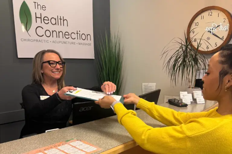Chiropractor discussing treatment options with a patient At Tacoma Chiropractic Health Connection