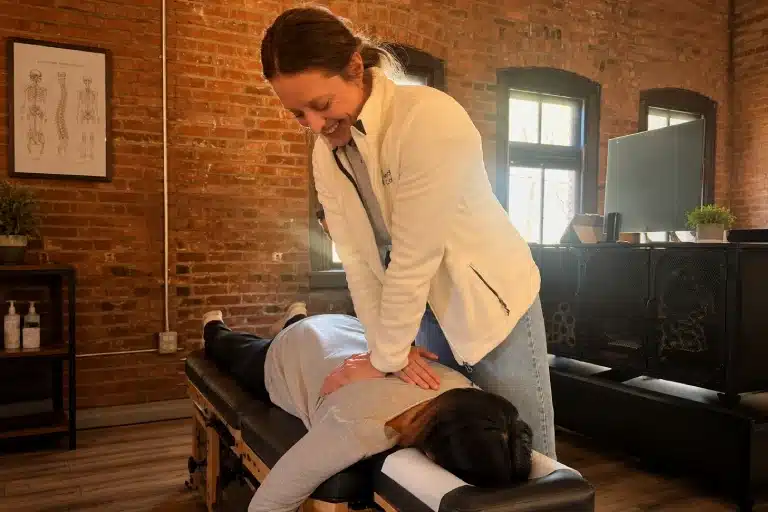 Chiropractor performing a hands-on spinal adjustment on a patient At Tacoma Chiropractic Health Connection