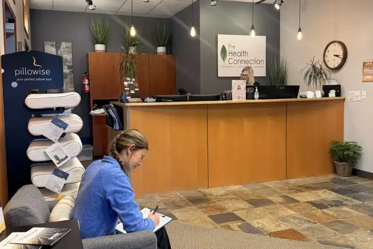 Patient completing paperwork near the Tacoma clinic reception desk