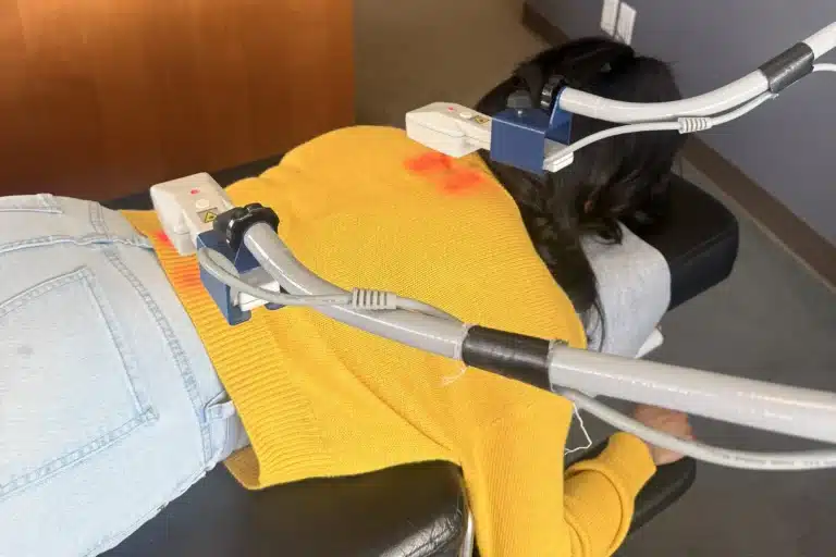 Patient receiving upper-back laser therapy at Tacoma Chiropractic Health Connection